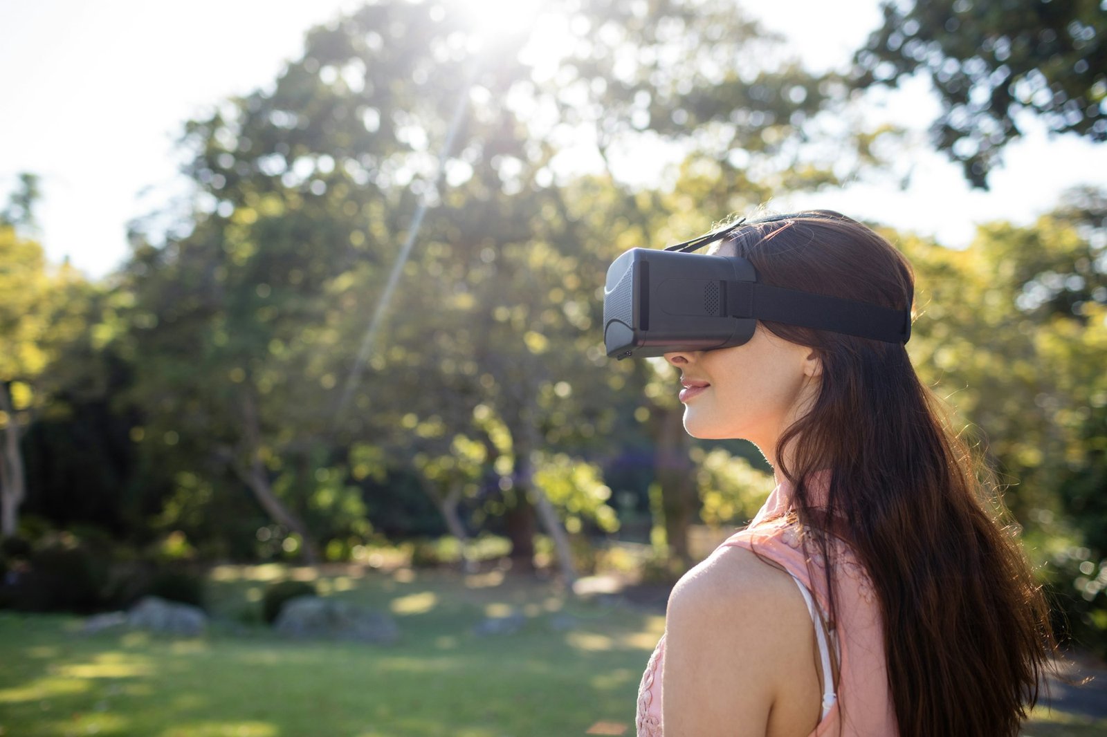 Woman using a VR headset in the park