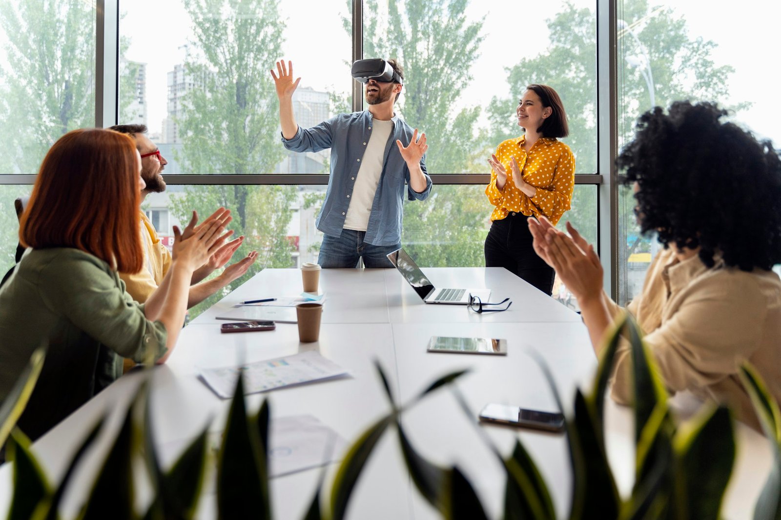 Young man wearing VR goggles, playing virtual reality online games during team building training